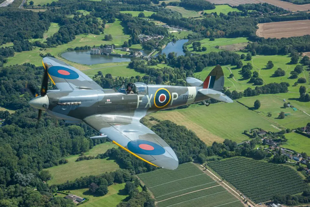 A spitfire flying over Leeds Castle, Kent. Photo by David Bell.